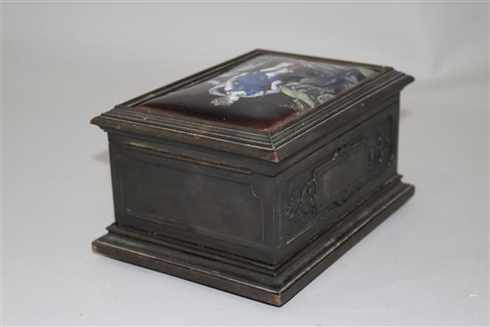 An early 19th century Limoges style enamel plaque set in a later carved ebonised casket, 7in.